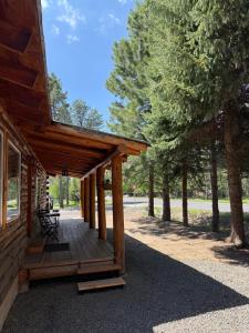 a wooden porch of a cabin with trees at Miller Cabin in McCall
