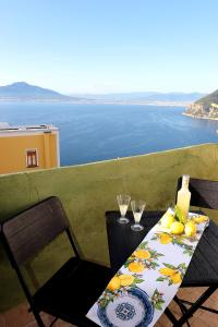 a table and chairs with a view of the ocean at Balcone sul Vesuvio in Vico Equense