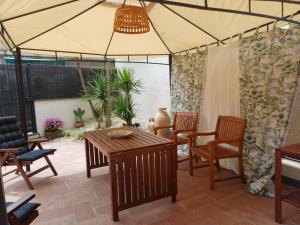 a patio with a table and chairs and a tent at Etna Docet in Nicolosi