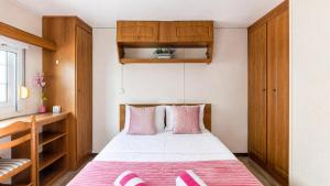 a small bedroom with a bed with pink pillows at 1A Casa Azul in Pataias +45 photos