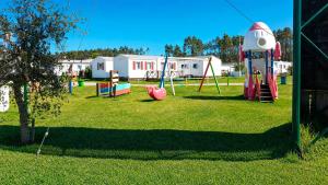 a park with a playground with a slide and a rocket at 1A Casa Azul in Pataias
