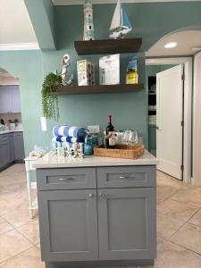 a kitchen with a gray island in a room at Waves, Sun & Relaxation Retreat in Clearwater Beach