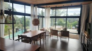 a living room with tables and chairs and a large window at lazy beach in Punta del Este