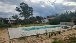 a swimming pool in the middle of a yard at lazy beach in Punta del Este