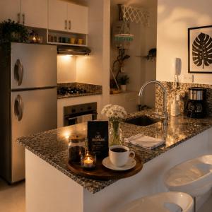 a kitchen with a counter with a cup of coffee on it at Morros 3 Frente al Mar - Piscinas y Jacuzzi in Cartagena de Indias