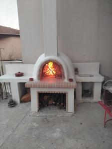 a brick oven with a fire inside of it at REPANTALIA Apartment in Zakynthos