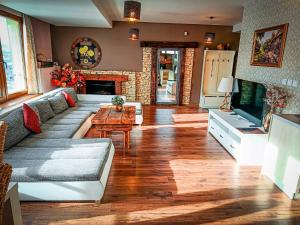 a living room with a couch and a table at Apartments Sofia plus in Liptovský Mikuláš