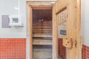 an open wooden door in a room with a microwave at Ocean View Luxury Duplex Apartment in Ovar +72 photos