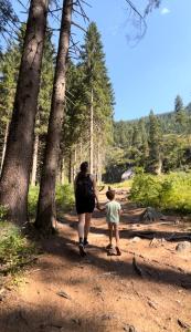 a woman and a child walking on a trail at Dimaro Apartment in Monclassico