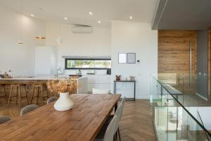 a kitchen and dining room with a wooden table at Villa Aurora Luxury Villa with Infinity Pool in Portimão