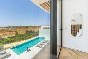 a house with a swimming pool with a view at Villa Aurora Luxury Villa with Infinity Pool in Portimão