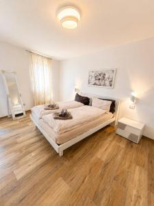 a bedroom with a large bed and a wooden floor at Casa Guerines in Tremosine Sul Garda