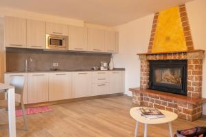 a kitchen with a fireplace and a stove at Casa Guerines in Tremosine Sul Garda