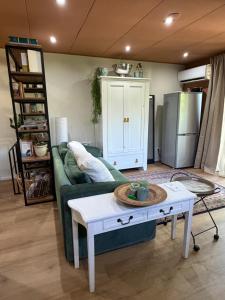 a living room with a green couch and a coffee table at Apartment Osso 2, Arnhem in Arnhem