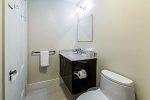 a bathroom with a toilet and a sink and a mirror at Beacon Hill Nights in Boston +24 photos