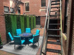a patio with a table and chairs on a balcony at Beacon Hill Nights in Boston