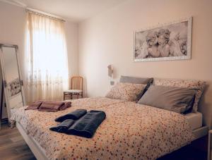 a bedroom with a bed with two towels on it at Casa Guerines in Tremosine Sul Garda +18 photos