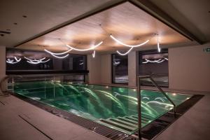 a swimming pool in the middle of a building at Paradise Lodge in Livigno +170 photos