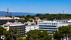 a group of buildings in a city with trees at Salou Beach Apartment with private Pool in Salou