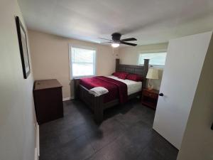 a bedroom with a bed and a ceiling fan at Beach Vacation Home in Rochester