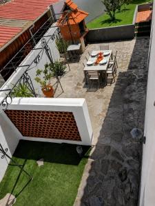 an overhead view of a patio with a table and chairs at Villa Herédia - 5 min form the beach in Ribeira Brava +17 photos