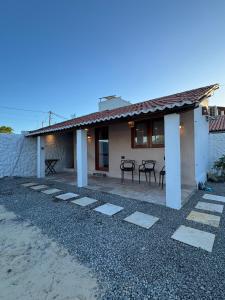 a house with a table and chairs in front of it at Guajiru Beach House KiteSurf in Trairi