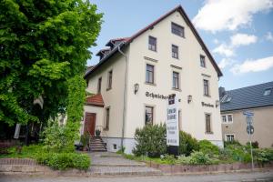 a white building with a sign in front of it at Aparthaus Schmiedeschenke in Dresden
