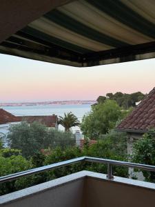 a view of the water from the balcony of a house at Apartmani Antea in Preko