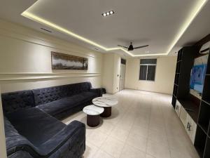 a living room with a couch and a tv at Janjua lodges Murree in Murree +5 photos
