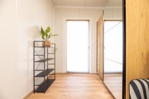 a hallway with a black book shelf and a mirror at Ubytovanie Pod Farou Bojnice in Bojnice +31 photos