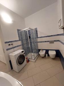 a bathroom with a washing machine and a toilet at Agriturismo La Fine in Piancaldoli