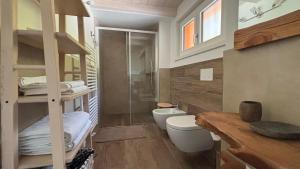a small bathroom with a toilet and a sink at Ledro Nest in Ledro +17 photos