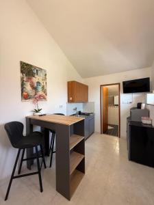 a kitchen with a desk and a table in a room at Apartmani Antea in Preko