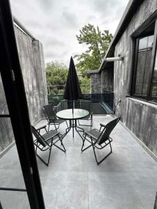 a patio with a table and chairs and an umbrella at dom in Tbilisi City