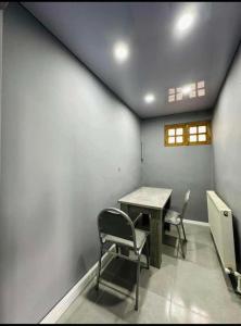 a room with a table and two chairs in it at dom in Tbilisi City