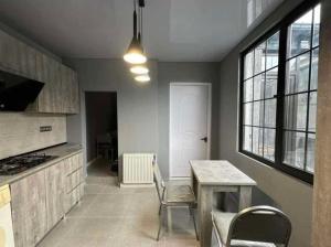 a kitchen with a table and chairs in a room at dom in Tbilisi City