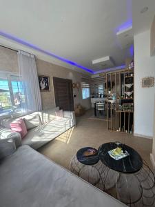 a living room with a couch and a table at Green Oasis in Bou Ficha