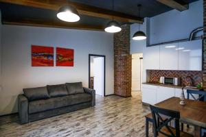 a living room with a couch and a table at Potocki Apartments in Lviv