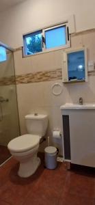 a bathroom with a toilet and a sink and window at Piedra de Luna o Sur in Villa Serrana +31 photos