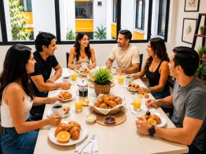 a group of people sitting around a table eating food at Hotel Mediterraneo Quito in Quito