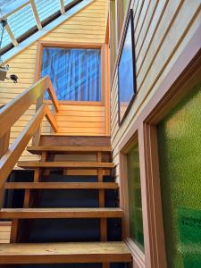 a wooden staircase leading up to a house at Casa Mañío Hostal Castro in Castro