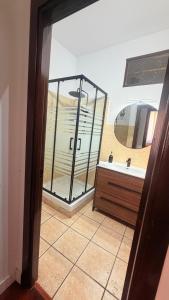 a bathroom with a tub and a sink and a mirror at Un Rincón en Alcalá in Alcalá de Henares