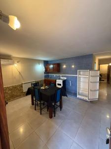 a kitchen with a table and chairs and a refrigerator at complejo laprida in Santa Lucía