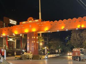 an orange bridge with yellow lights in front of a building at JAGTARA RESIDENCY in Indore