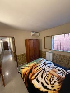 a bedroom with a tiger print bed in a room at complejo laprida in Santa Lucía