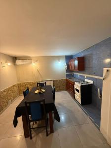 a kitchen with a dining table and a stove at complejo laprida in Santa Lucía