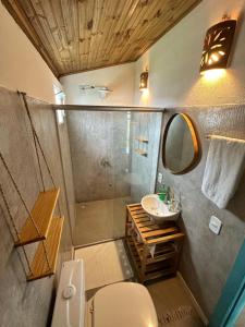 a bathroom with a toilet and a sink and a shower at OCA Caraíva in Caraíva +94 photos