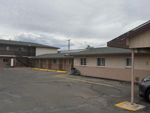 a parking lot in front of a building at Encore Motel in Farmington