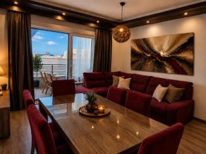 a living room with a red couch and a table at Johanan in Makarska