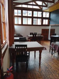 a dining room with tables and chairs and windows at Da Vinci in Valparaíso